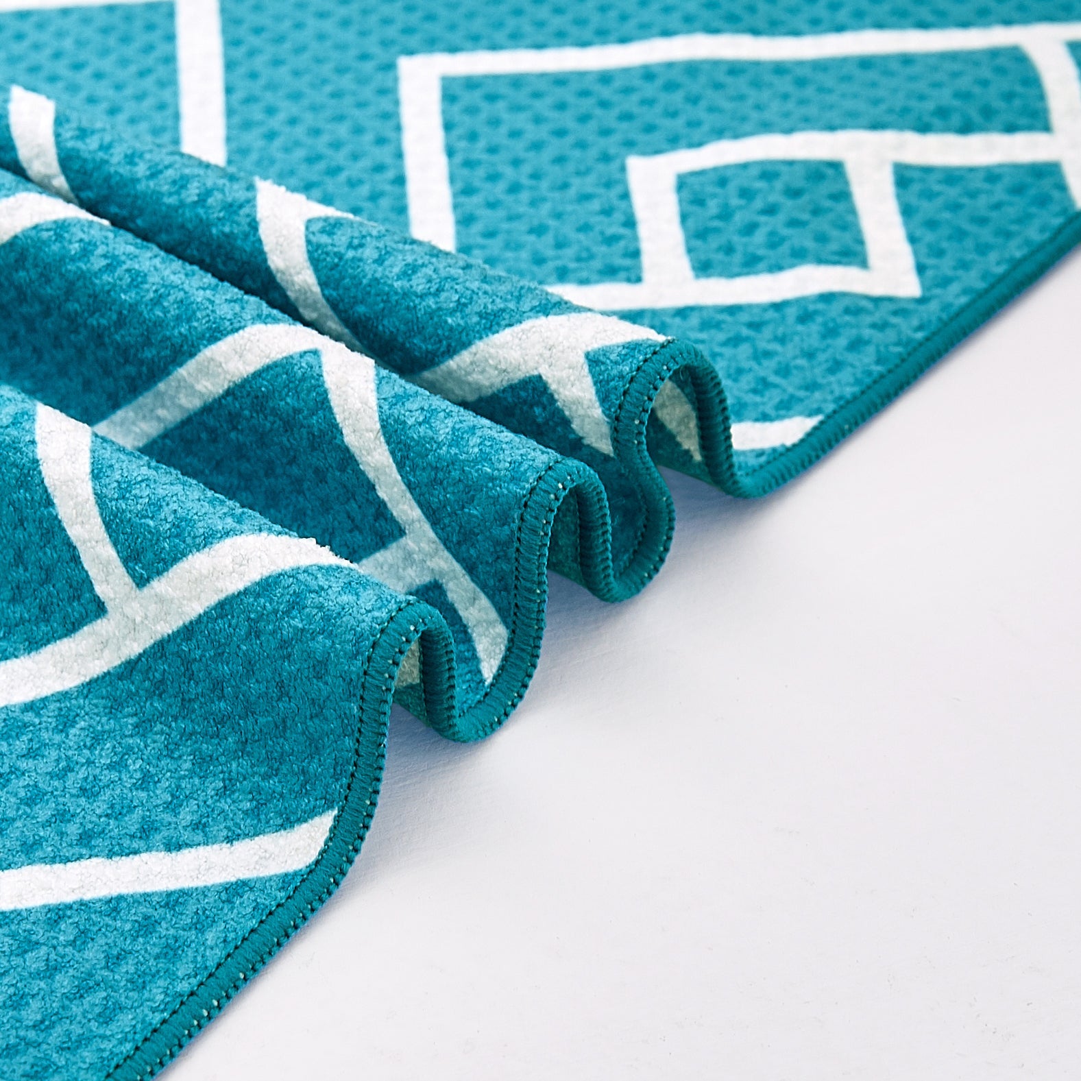 Close-up of teal waffle-weave microfibre bath towel